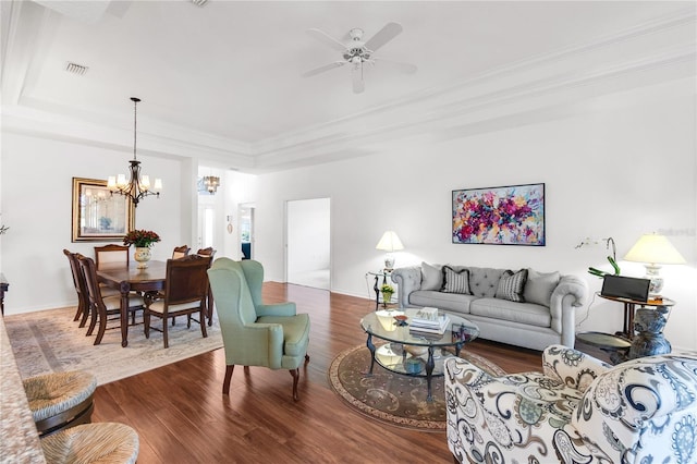 315 Heritage Isles Way, Bradenton, FL 34212 - living room with a tray ceiling, a chandelier, wood finished floors, ornamental molding, and a ceiling fan