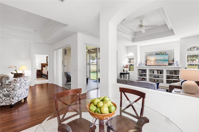 315 Heritage Isles Way, Bradenton, FL 34212 - living area featuring a raised ceiling, ceiling fan, ornamental molding, and plenty of natural light