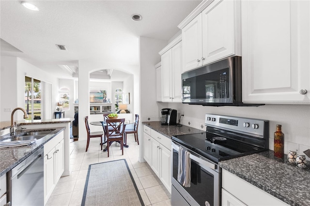 315 Heritage Isles Way, Bradenton, FL 34212 - kitchen with appliances with stainless steel finishes, a sink, white cabinetry, dark stone countertops, and recessed lighting