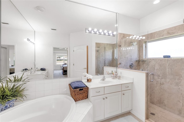 315 Heritage Isles Way, Bradenton, FL 34212 - ensuite bathroom featuring a shower stall, plenty of natural light, a bath, and vanity