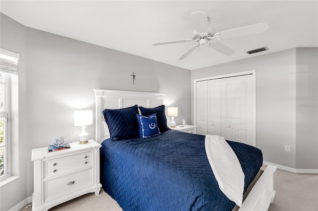315 Heritage Isles Way, Bradenton, FL 34212 - bedroom with light carpet, a closet, baseboards, and ceiling fan