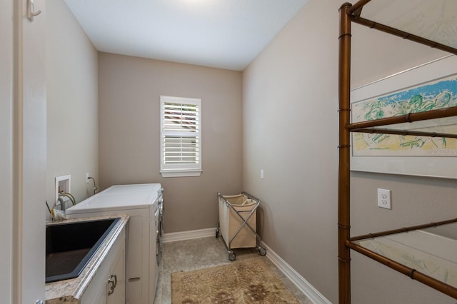 laundry area featuring cabinet space, separate washer and dryer, and baseboards