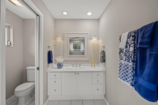 6664 Deering Cir, Sarasota, FL 34240 - bathroom featuring baseboards, vanity, toilet, and tile patterned flooring