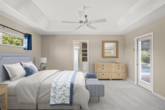 6664 Deering Cir, Sarasota, FL 34240 - bedroom with a raised ceiling, access to exterior, light colored carpet, baseboards, and a ceiling fan