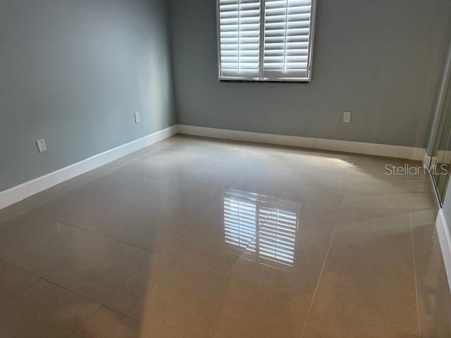 2616 Hidden Lake Dr N Unit A, Sarasota, FL 34237 - spare room with tile patterned floors