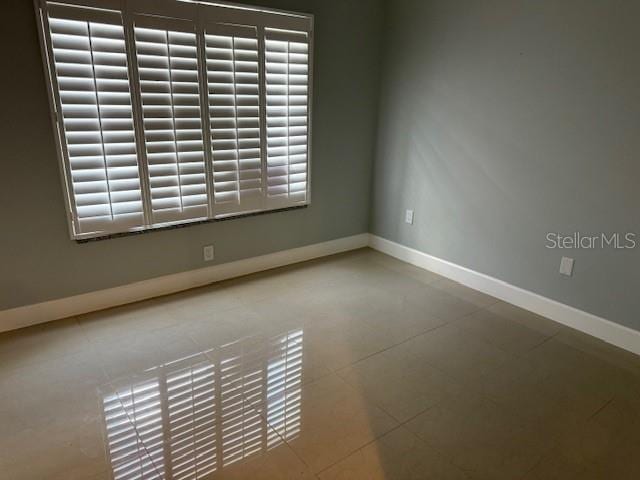 2616 Hidden Lake Dr N Unit A, Sarasota, FL 34237 - tiled spare room with baseboards