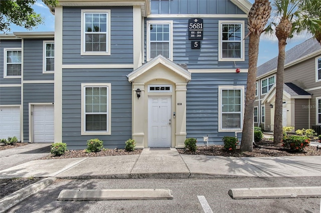 5681 Bidwell Pkwy Unit 102, Sarasota, FL 34233 - townhome / multi-family property with board and batten siding and a garage