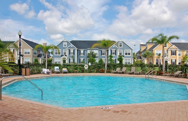 5681 Bidwell Pkwy Unit 102, Sarasota, FL 34233 - community pool featuring a residential view and fence
