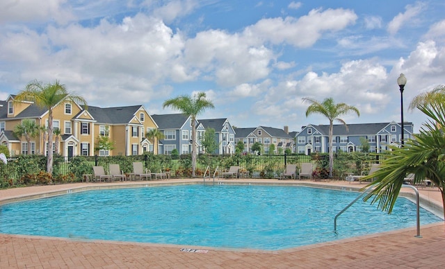 5681 Bidwell Pkwy Unit 102, Sarasota, FL 34233 - community pool featuring a residential view and fence