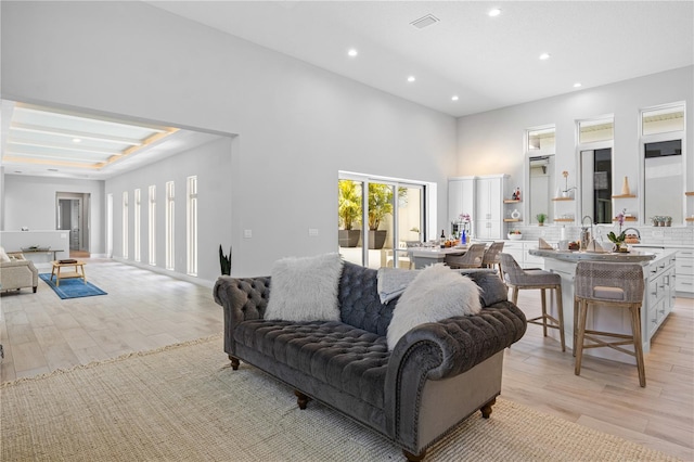 5910 Red Mangrove Ln, Bradenton, FL 34210 - living room with light wood-style flooring, recessed lighting, and a high ceiling