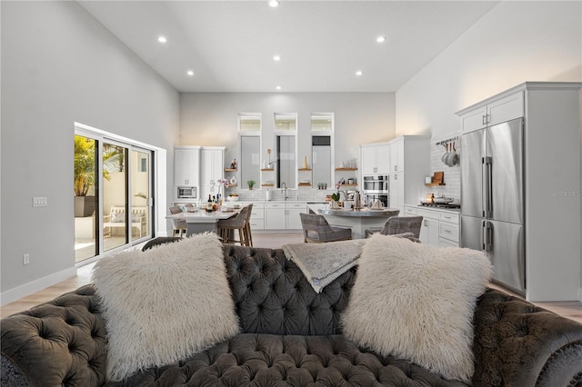 5910 Red Mangrove Ln, Bradenton, FL 34210 - living area featuring recessed lighting, light wood-style floors, baseboards, and a high ceiling
