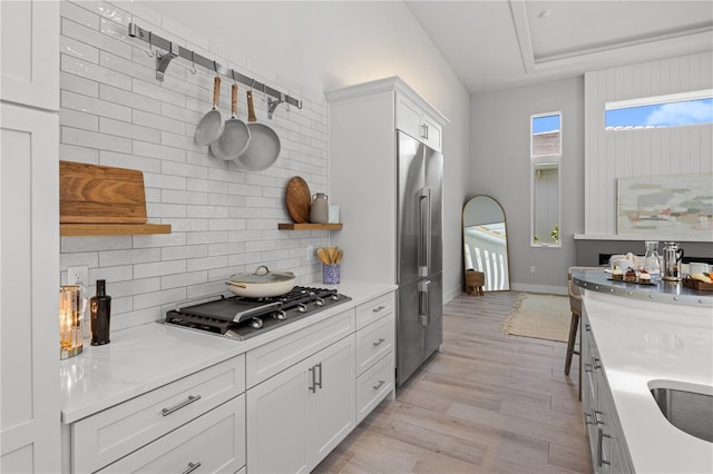5910 Red Mangrove Ln, Bradenton, FL 34210 - kitchen with appliances with stainless steel finishes, open shelves, light wood-style floors, and tasteful backsplash