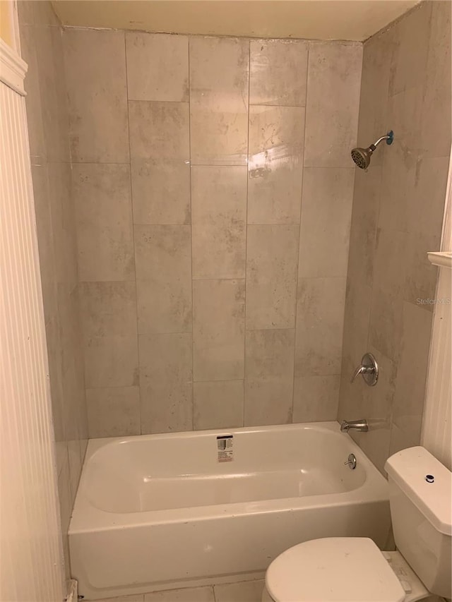 bathroom featuring toilet, shower / bathtub combination, and tile patterned floors