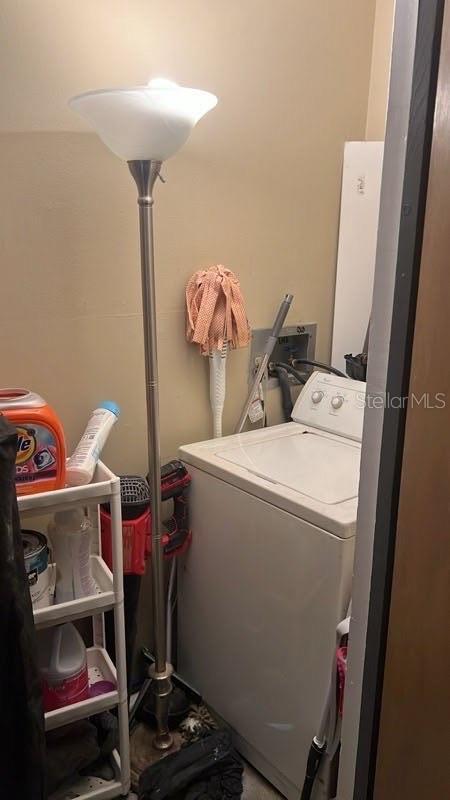 clothes washing area featuring washer / dryer