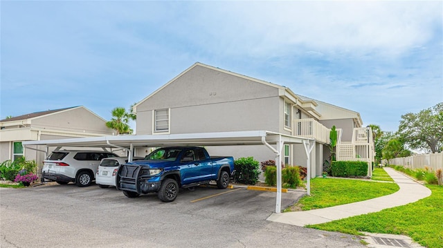 5964 7th Ave W Unit 5964, Bradenton, FL 34209 - view of home's exterior featuring covered parking and a yard