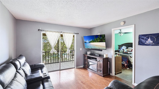 5964 7th Ave W Unit 5964, Bradenton, FL 34209 - living area featuring wood finished floors, a textured ceiling, a ceiling fan, and baseboards