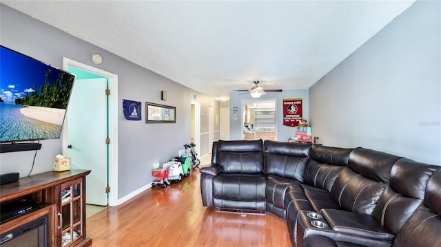 5964 7th Ave W Unit 5964, Bradenton, FL 34209 - living room featuring wood finished floors, ceiling fan, and baseboards