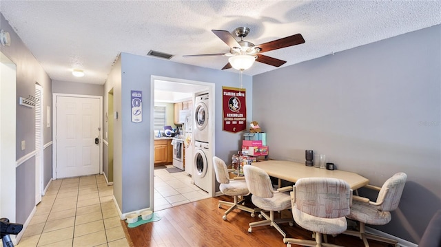 5964 7th Ave W Unit 5964, Bradenton, FL 34209 - dining space with stacked washer / dryer, a ceiling fan, a textured ceiling, light tile patterned floors, and an office area