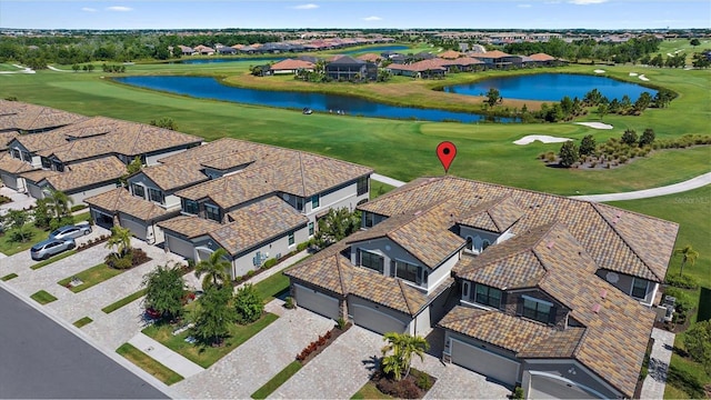 aerial perspective of suburban area with a large body of water and a local golf course