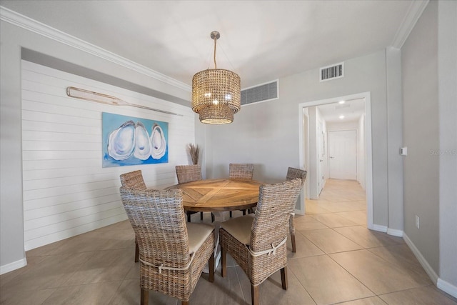dining room with a chandelier, ornamental molding, light tile patterned flooring, and baseboards