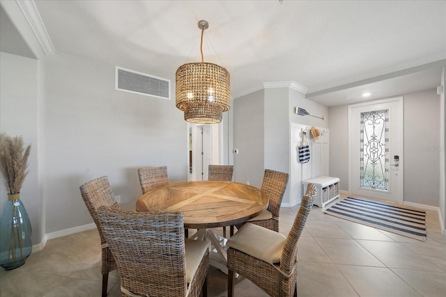 dining room featuring a chandelier, light tile patterned flooring, ornamental molding, and baseboards