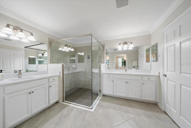 full bathroom featuring a chandelier, crown molding, a stall shower, tile patterned flooring, and two vanities