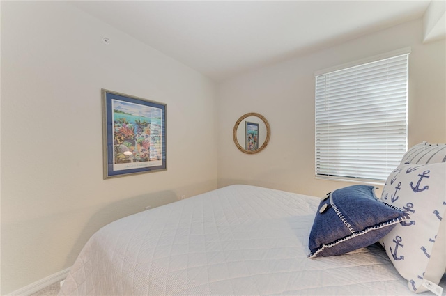 carpeted bedroom with baseboards