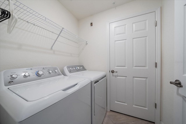 laundry area featuring separate washer and dryer and tile patterned flooring