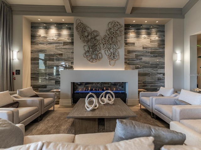 living area featuring a glass covered fireplace, an accent wall, beamed ceiling, recessed lighting, and tile walls