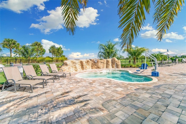 view of swimming pool with fence and a patio