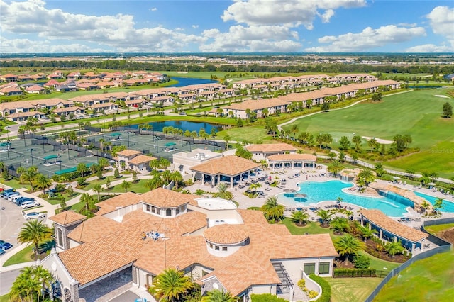 aerial perspective of suburban area featuring a large body of water, a local golf course, and a pool area