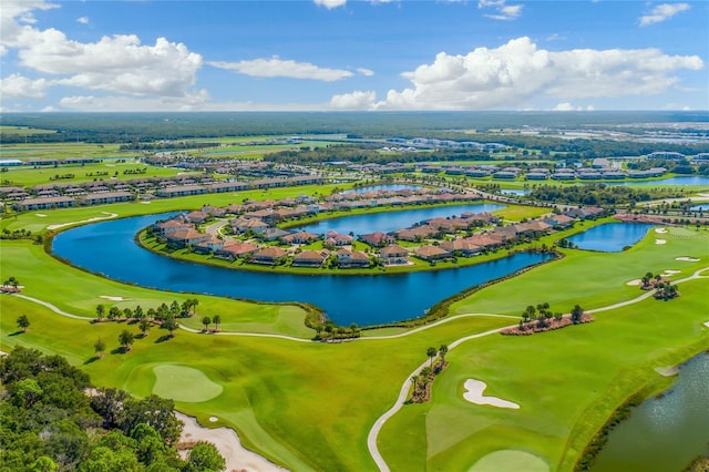 aerial view of residential area featuring a golf course and a nearby body of water