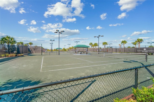 view of tennis court featuring fence