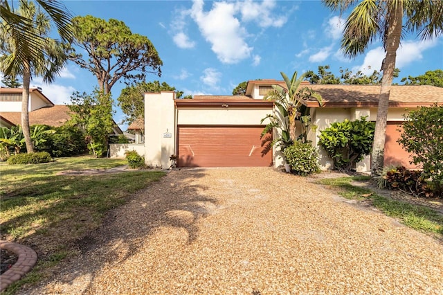 view of front of house with stucco siding, driveway, and an attached garage