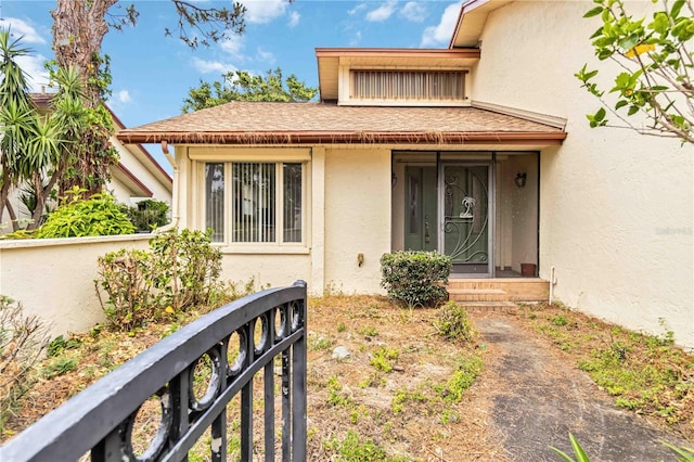 view of exterior entry featuring stucco siding