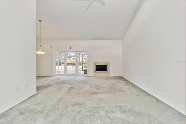 unfurnished living room with carpet, a fireplace, ceiling fan, lofted ceiling, and baseboards