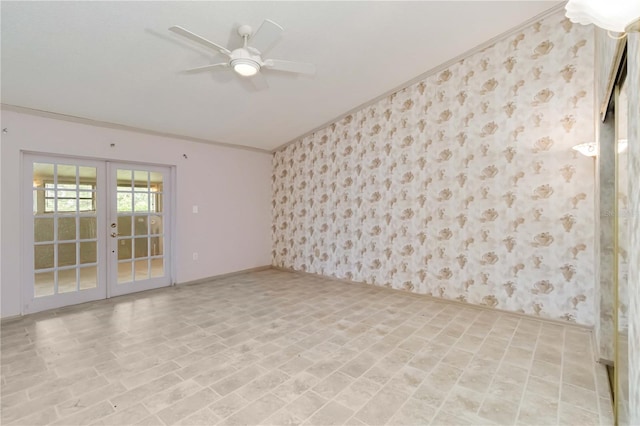 spare room with wallpapered walls, baseboards, french doors, a ceiling fan, and crown molding