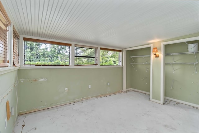 unfurnished bedroom with two closets