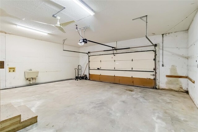 garage featuring a sink and a garage door opener