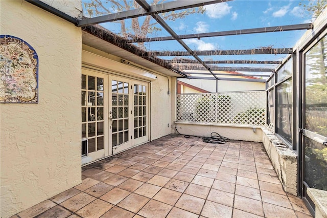 unfurnished sunroom with french doors