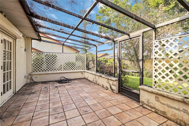 view of patio / terrace featuring glass enclosure