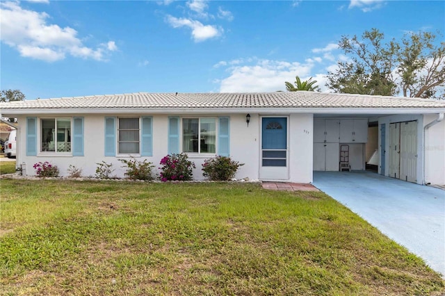 577 Circlewood Dr Unit X7, Venice, FL 34293 - ranch-style house featuring a tile roof, concrete driveway, a carport, a front yard, and stucco siding