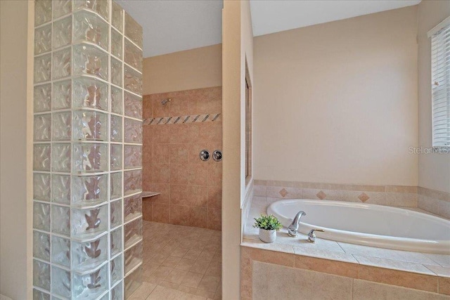 4978 Cedar Oak Way, Sarasota, FL 34233 - bathroom featuring walk in shower, a garden tub, and tile patterned floors