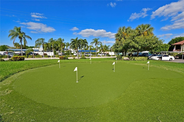 surrounding community with a putting area and a lawn