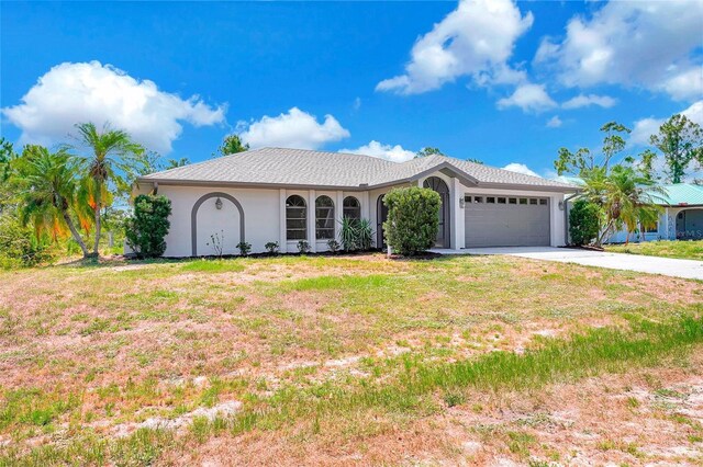 3510 Shawn St, Punta Gorda, FL 33980 - ranch-style home with a garage, stucco siding, concrete driveway, and a front lawn