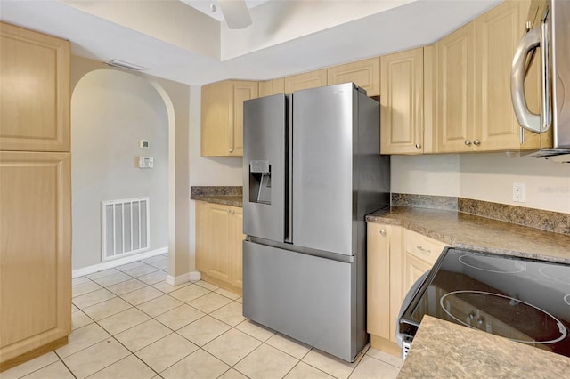 3510 Shawn St, Punta Gorda, FL 33980 - kitchen with appliances with stainless steel finishes, light brown cabinets, arched walkways, light tile patterned floors, and a ceiling fan