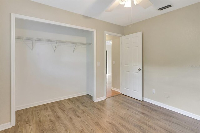 3510 Shawn St, Punta Gorda, FL 33980 - unfurnished bedroom featuring light wood-style flooring, a closet, baseboards, and a ceiling fan
