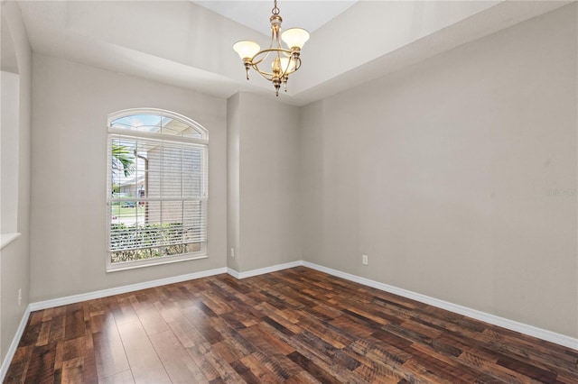 7626 Double Pine Dr, Sarasota, FL 34240 - unfurnished room featuring a chandelier, dark wood-type flooring, and baseboards