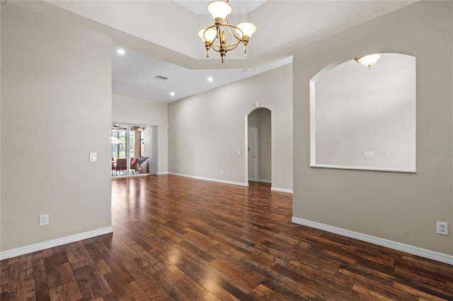 7626 Double Pine Dr, Sarasota, FL 34240 - unfurnished room with arched walkways, a chandelier, wood finished floors, recessed lighting, and baseboards