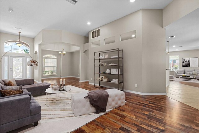 7626 Double Pine Dr, Sarasota, FL 34240 - living room featuring wood finished floors, recessed lighting, baseboards, a chandelier, and a high ceiling